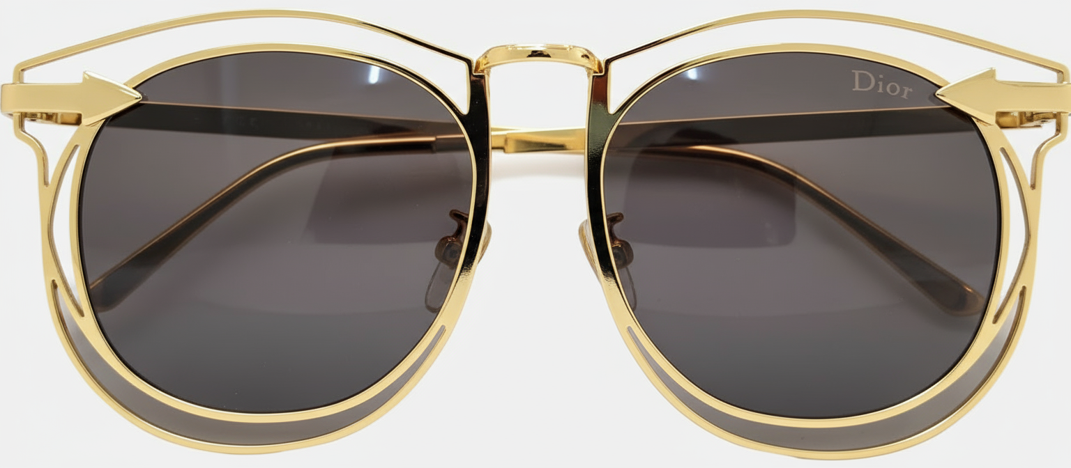 Gold-framed sunglasses with dark lenses on a white background